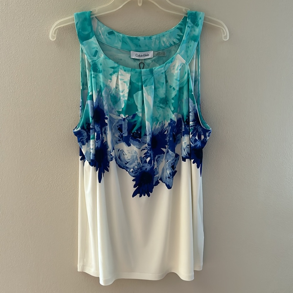 Calvin Klein sleeveless blouse. Cream color with green and blue floral accents